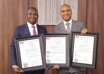 TAJBank’s Chief Marketing Officer,  Sherif Idi and Managing Director, Hamid Joda displaying the ISO certificates