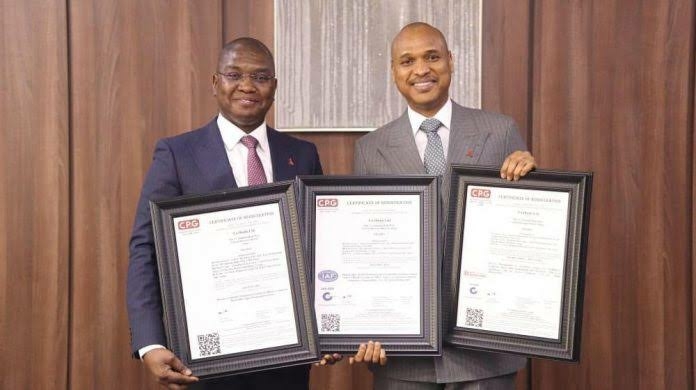 TAJBank’s Chief Marketing Officer,  Sherif Idi and Managing Director, Hamid Joda displaying the ISO certificates