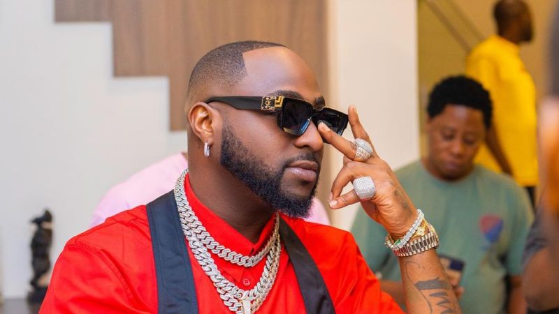 Generous Davido Shares Dollar Notes To Airport Workers, Fans (Video)