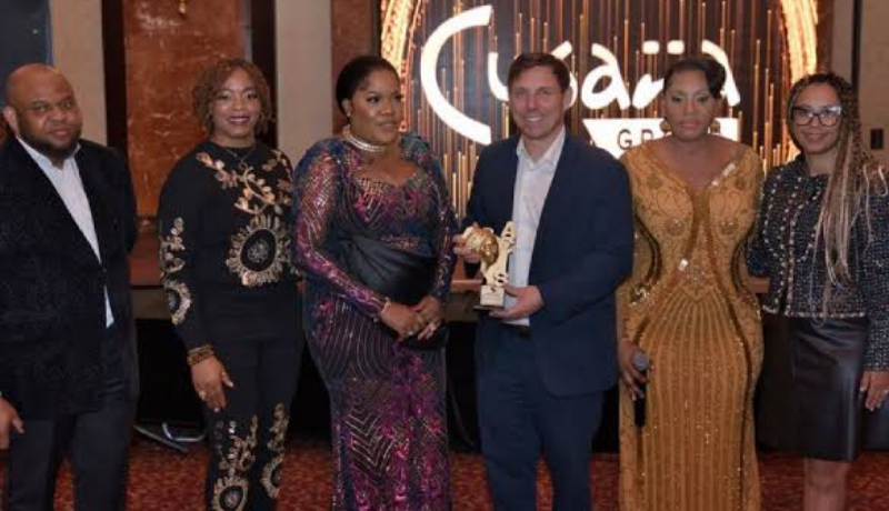Nollywood actress, Toyin Abraham posing with the award organizers