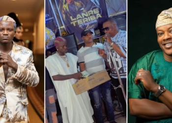 Portable makes money rain on gospel singer Lanre Teriba at odogwu bar [VIDEO]