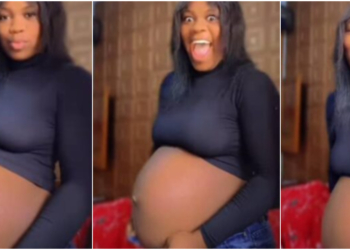 Pregnant lady playfully alters her enlarged bump