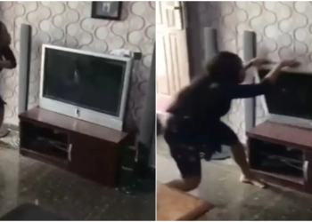 Nigerian lady destroys boyfriend's TV in anger over alleged affair