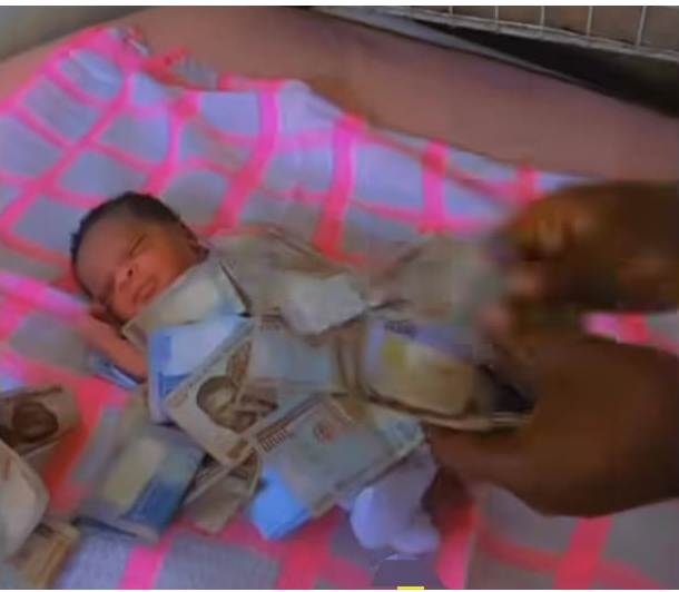 Nigerian man sprays money on his newborn baby, Netizens fume