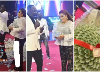 Church members make it rain money on pastor's wife's birthday during church service