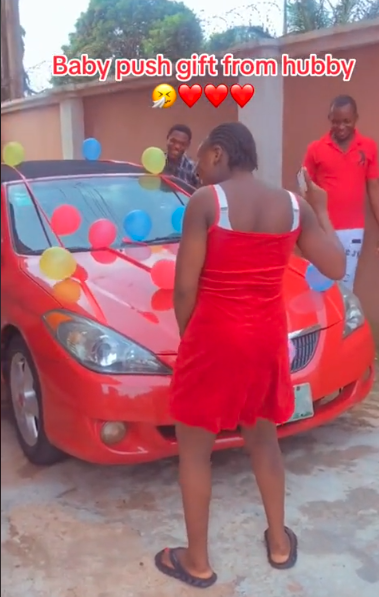 Lady receives red convertible car as push gift from husband