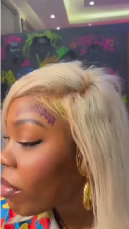 Video of Nigerian lady tattooing Shallipopi's name on her forehead causes buzz online