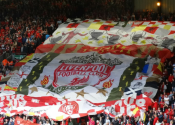 Liverpool supporters holding flag at Anfield