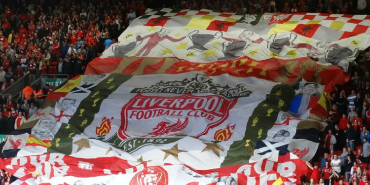 Liverpool supporters holding flag at Anfield