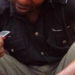 Arrested Nigerian policeman being interrogated by journalist