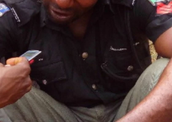 Arrested Nigerian policeman being interrogated by journalist