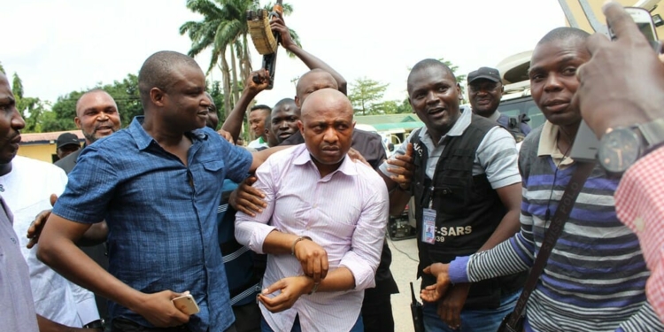 Kyrai and team posing with suspected kidnapper, Evans, after his arrest