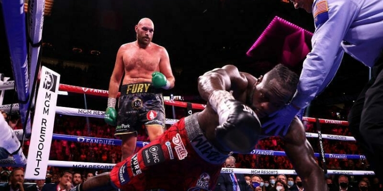 Deontay Wilder reacts to getting knocked out by Tyson Fury in trilogy fight