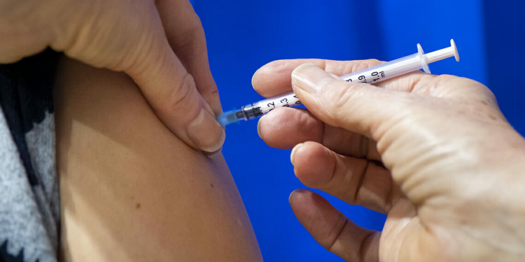A close-up of a syringe containing a Pfizer-BioNTech Covid-19 vaccine as it is given to a patient in Cardiff, Wales