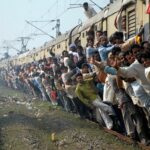 Depict image - overloaded moving train in India