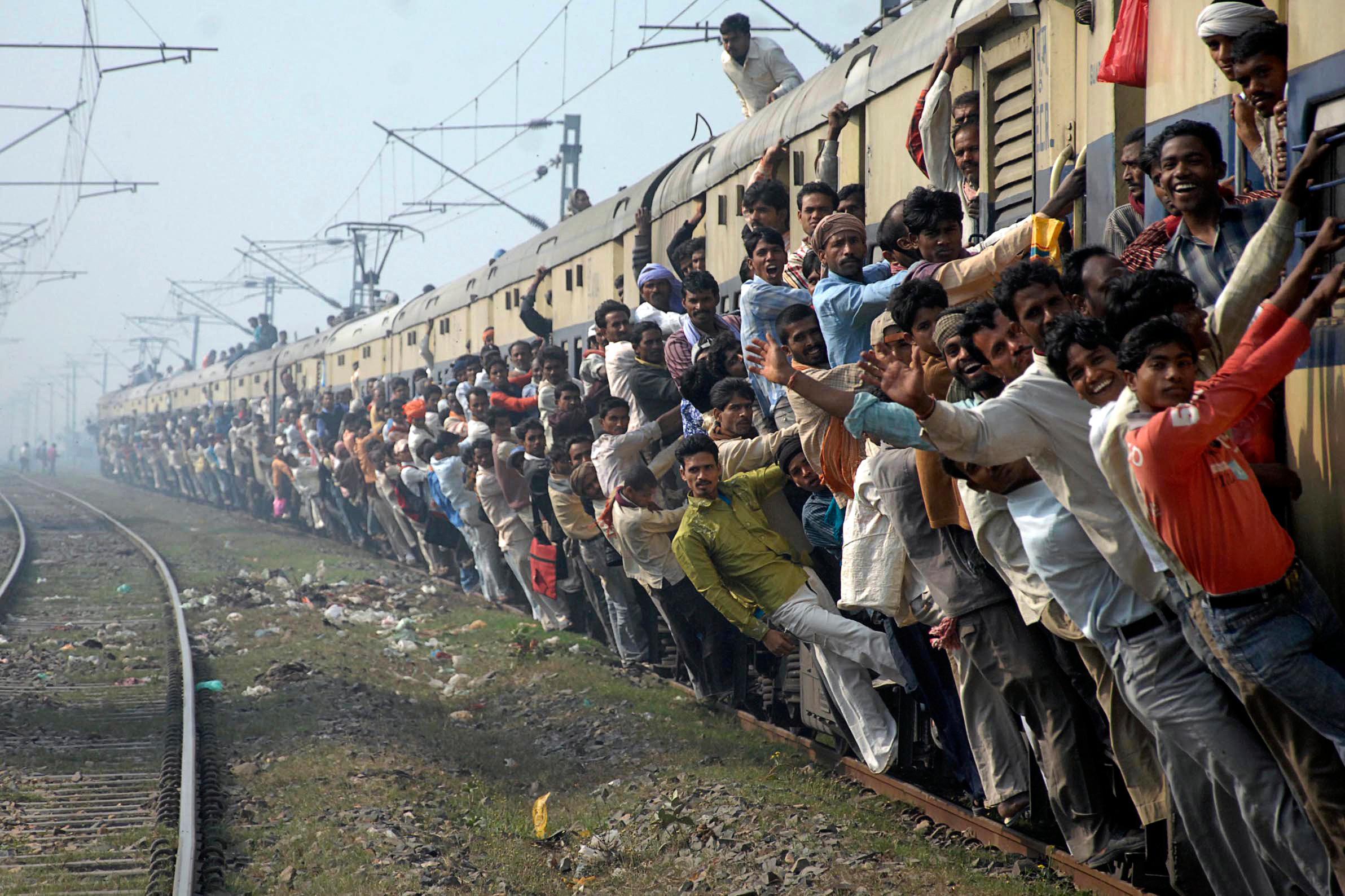 Depict image - overloaded moving train in India