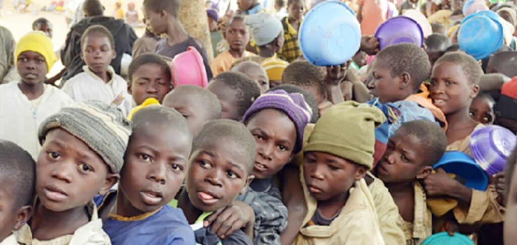 Young Almajiri boys wait in line for food in northern Nigeria