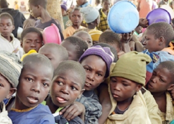 Young Almajiri boys wait in line for food in northern Nigeria