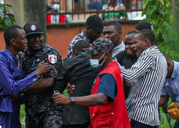 A file image of security operatives arresting a suspected vote buyer during an election