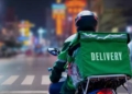A delivery driver riding a motorcycle