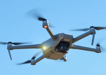 Drone flying in blue sky
