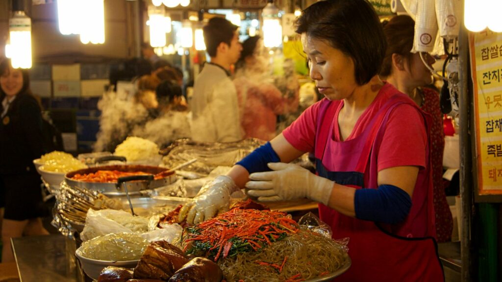 woman in red and white long sleeve shirt sitting on chair
