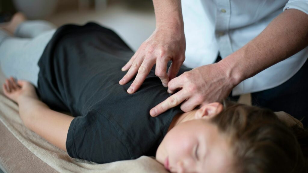 a woman getting a back massage from a massager