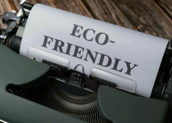 a close up of a typewriter with a paper that reads eco - friendly