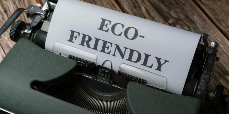 a close up of a typewriter with a paper that reads eco - friendly