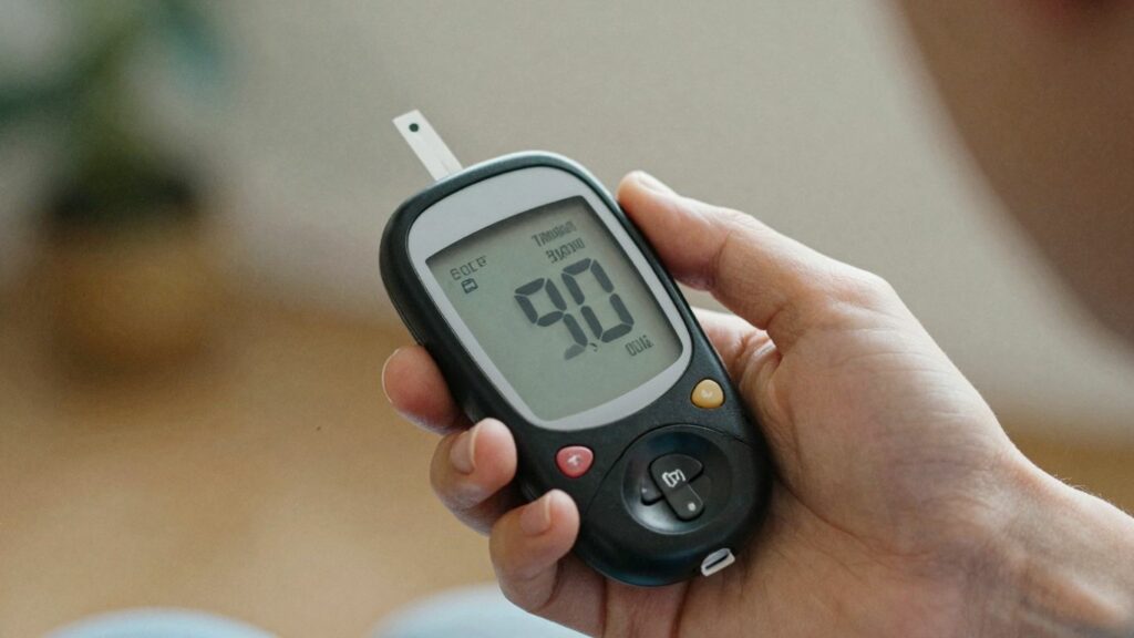 Person checking blood sugar with a glucose meter.