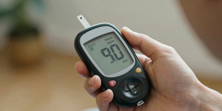 Person checking blood sugar with a glucose meter.