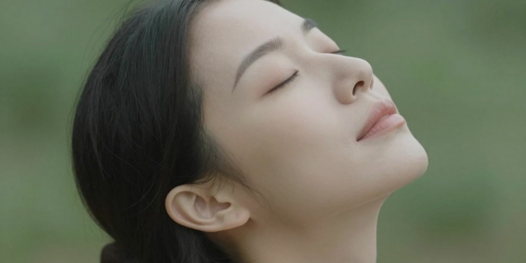 Woman practicing deep breathing for anxiety relief.
