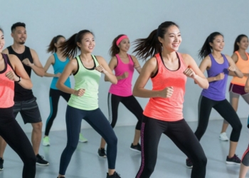 People dancing energetically in a Zumba workout class.