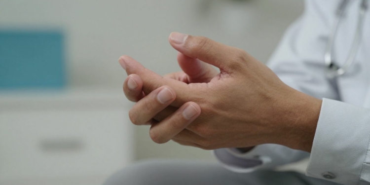 Hands with a slight tremor, Parkinson's disease symptom.