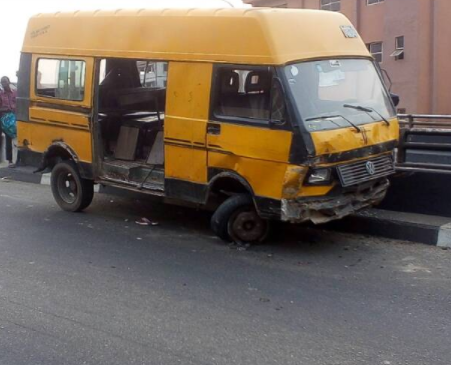 Hawker falls off the bridge after he is hit by a commercial bus in Lagos (photos)