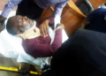 Olisa Metuh on a stretcher in court.