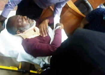 Olisa Metuh on a stretcher in court.