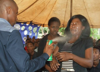 Pastor Lethebo Rabalago using insecticide during deliverance session in his church