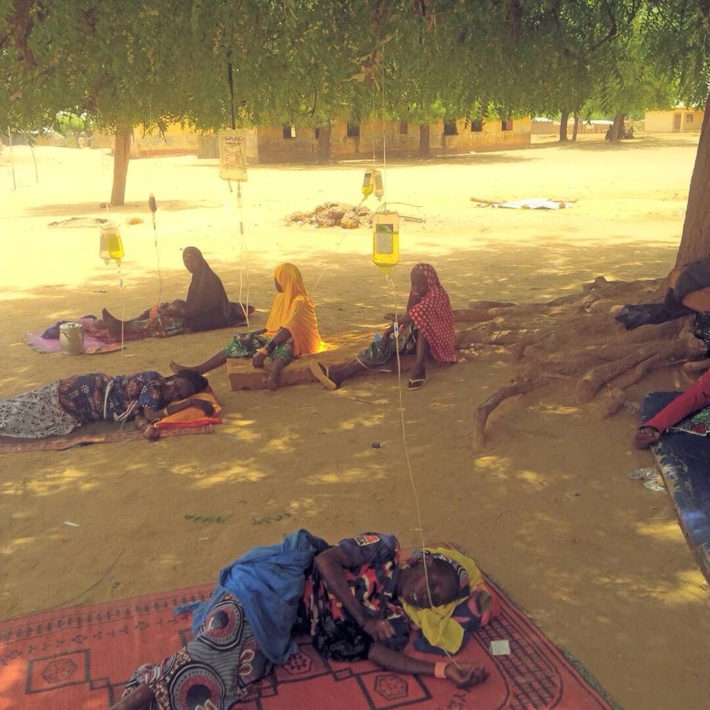 Shocking photo of ailing Sokoto state residents receiving drip under a tree at a public health center