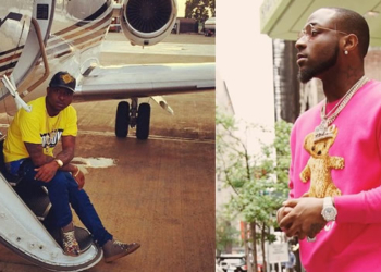 Davido posing near a private jet
