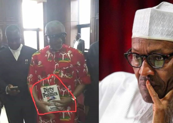 Senator Enyinnaya Abaribe holding a book titled 'Dirty Politics'