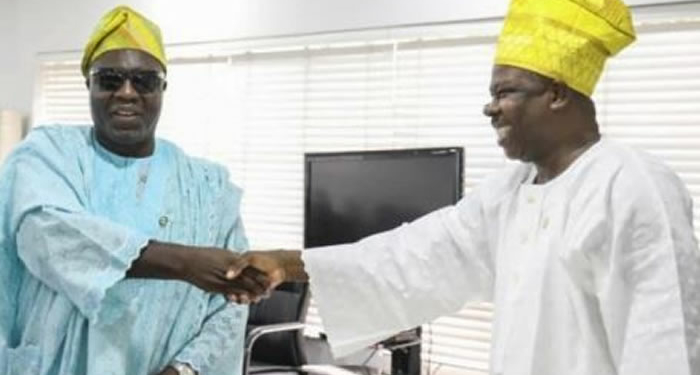 Visually impaired Akinyemi Andrew Elijah exchanging handshake with Governor Amosu