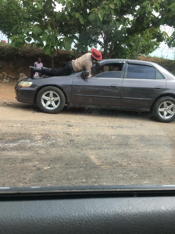 Photos: FRSC official jumps on the moving vehicle of a motorist who refused to stop for him