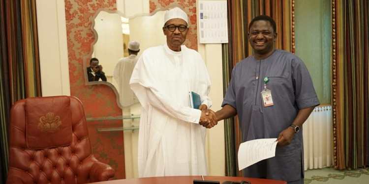 President Buhari and his Special Adviser, Femi Adesina, exchanging pleasantries