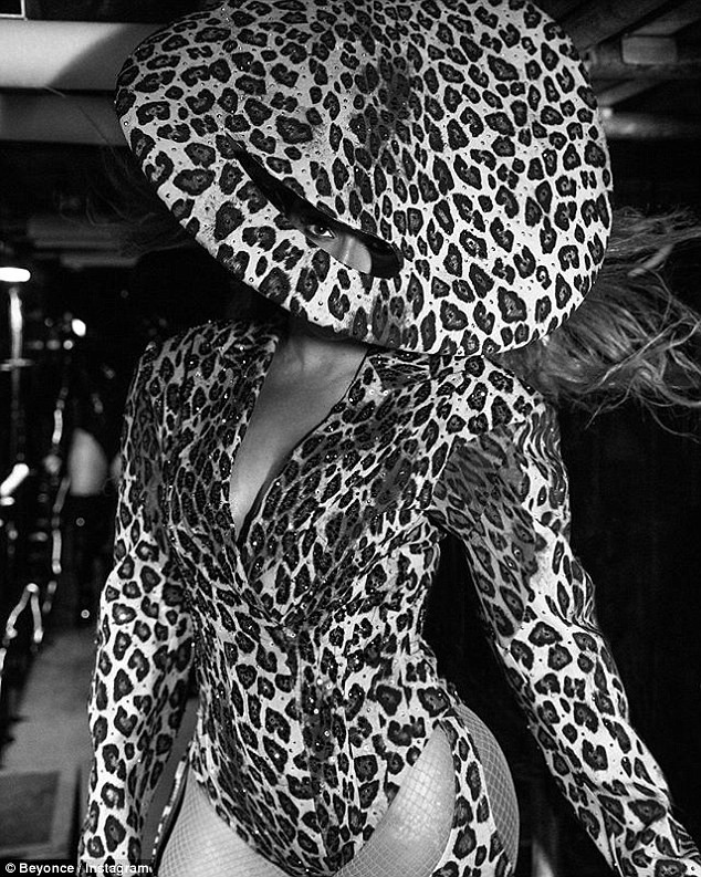 Beyonce flaunts her long legs in fierce leopard print leotard and matching thigh-high boots in new photos