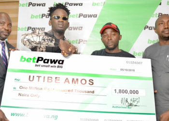 From left to Right: Managing Director/CEO, Mr. Segun Somefun, betPawa ambassador Mr. Eazi, a winner Utibe Amos and head information and technology Lagos state lottery board Mr. Remi Iwayemi during the official presentation of the cheque to the winner .