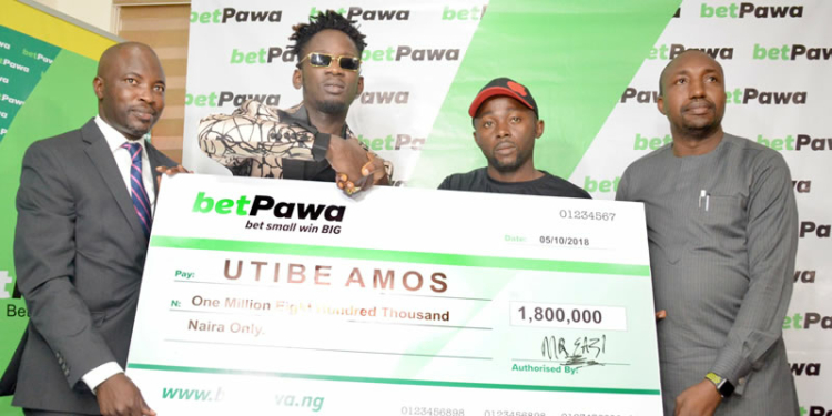 From left to Right: Managing Director/CEO, Mr. Segun Somefun, betPawa ambassador Mr. Eazi, a winner Utibe Amos and head information and technology Lagos state lottery board Mr. Remi Iwayemi during the official presentation of the cheque to the winner .