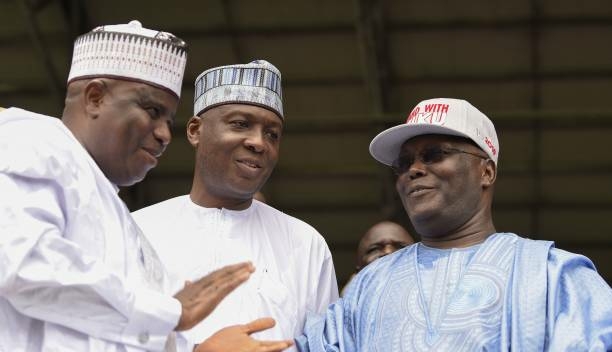 Former Nigerian vice-President Atiku Abubakar (R) is congratulated by runners-up Sokoto State Governor Aminu Tambuwal (L) and Senate President Bukola Saraki (C) after winning the presidential ticket of the opposition People's Democratic Party (PDP) during the party's national convention in Port Harcourt, Rivers State on October 7, 2018. - Nigeria's main opposition Peoples Democratic Party (PDP) has picked Abubakar to challenge President Muhammadu Buhari who is seeking a second term in presidential polls scheduled for February 2019. (Photo by PIUS UTOMI EKPEI / AFP) (Photo credit should read PIUS UTOMI EKPEI/AFP/Getty Images)