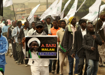 Nigeria Shiite Muslims hold religious flags and banners in a procession celebrating Prophet Muhammad’s birthday and also demanding the release of Shiite leader Ibraheem Zakzaky, on posters, in Kano, Nigeria, Thursday, Dec. 24, 2015. The demonstration was in part provoked after a recent attack by Nigerian soldiers who fired on unarmed Islamic Shiite children with no provocation, killing some hundreds of the minority group in the West African nation, according to a report from Human Rights Watch. (AP Photo/Muhammed Giginyu)