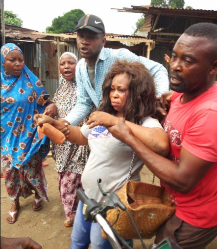 Suspected kidnapper is brutally beaten after she was allegedly caught trying to steal a 2-month-old baby (photos)